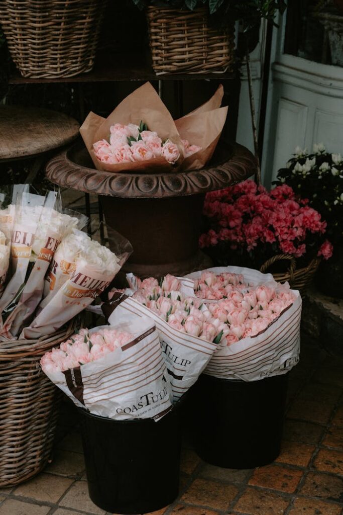 A beautiful arrangement of pink roses in a market setting, showcasing floral abundance.